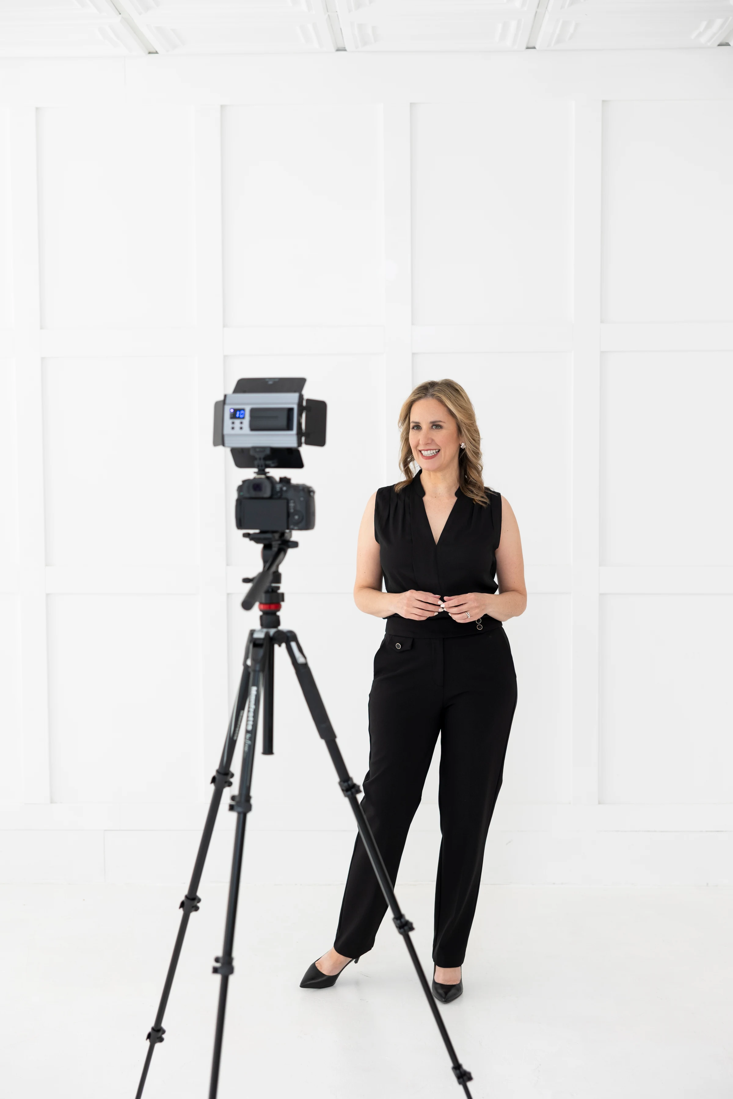Laressa Watlington presenting beside a professional video camera