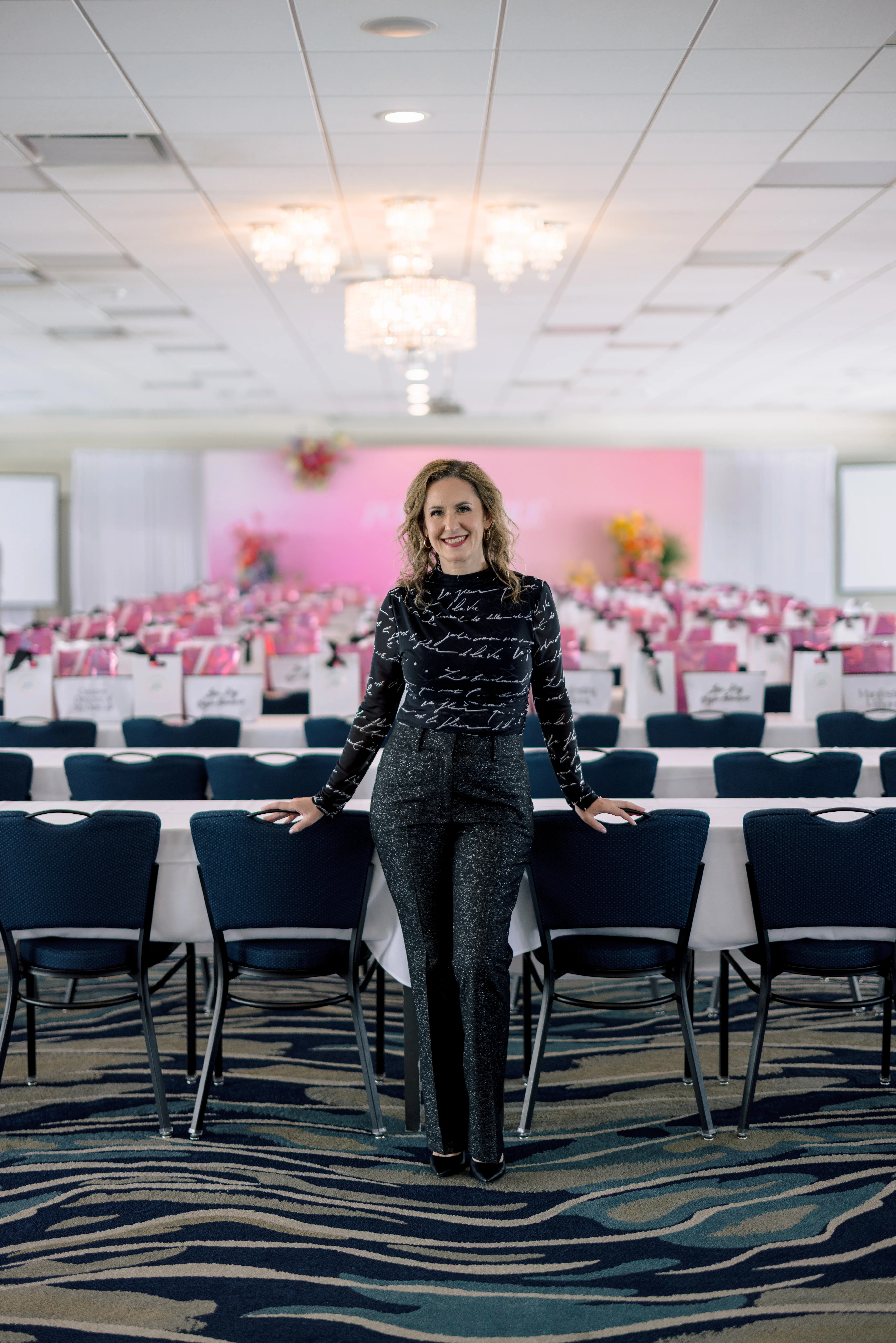 Laressa Watlington rehearsing on camera in a professional event space