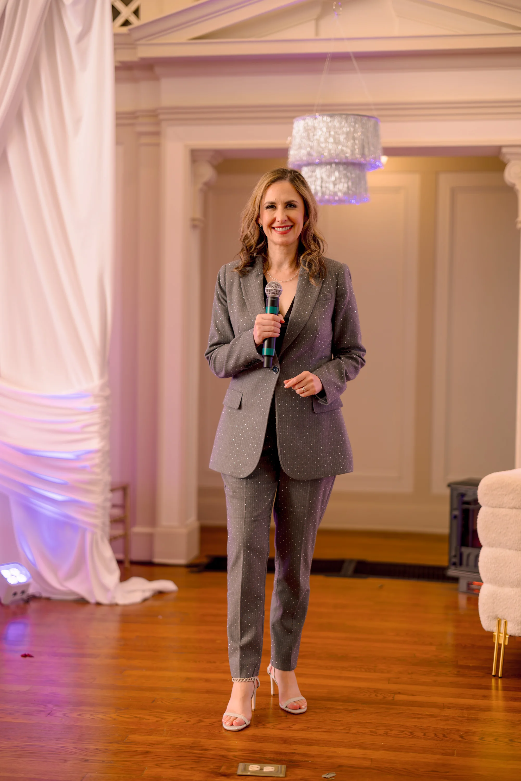 Laressa Watlington speaking to an audience with a handheld microphone