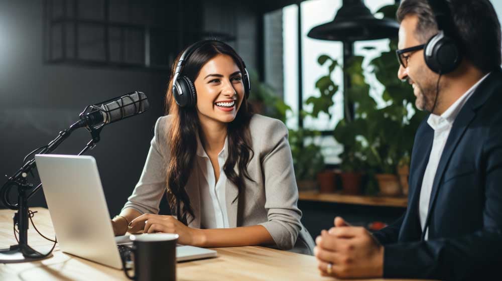 Woman with headphones coaching a client on speaking techniques, aiming to enhance presence and public speaking skills.